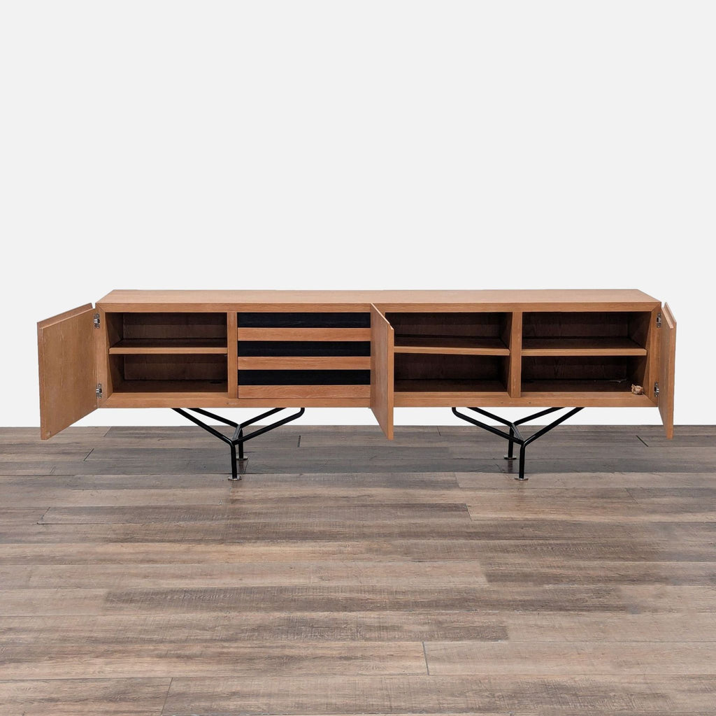 2. Oak credenza with open cabinets showing adjustable shelves, three ebonized drawers, and powder-coated legs.