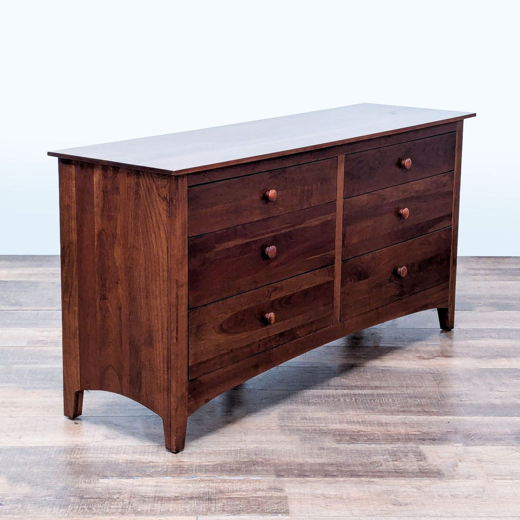 3. Angled view of Ethan Allen cherry dresser, featuring six flush drawers, woodgrain, and handcrafted details.