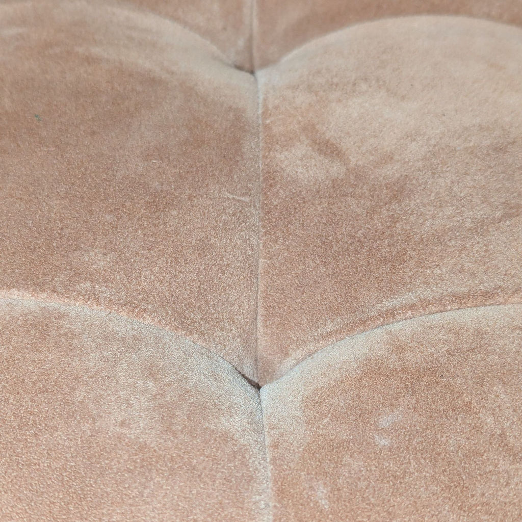 2. Close-up of camel suede upholstery with deep tufting texture and soft, velvety surface.