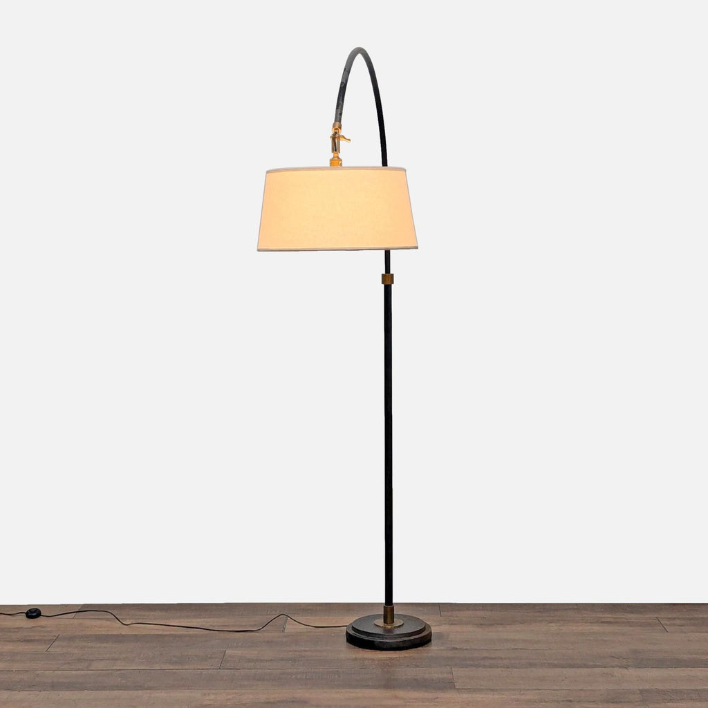 Hand-finished aged steel floor lamp by Pottery Barn with pivoting head, diffuser, and antiqued brass accents.  