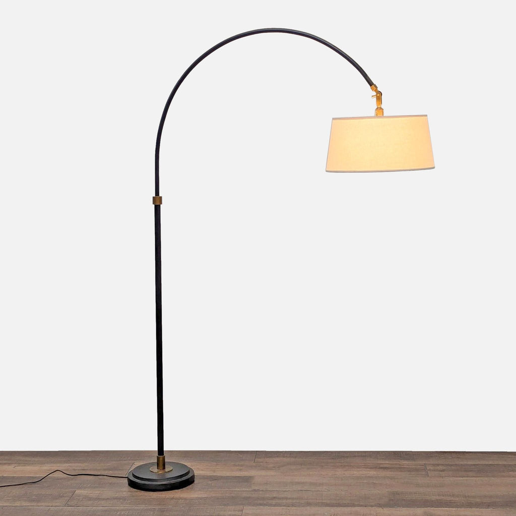 Pottery Barn lighting with a weighted base, arched adjustable stem, and an antiqued brass detail on aged steel.  