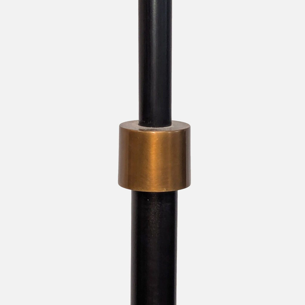 Close-up of an aged steel Pottery Barn lamp’s antiqued brass accent, highlighting the hand-finished craftsmanship.