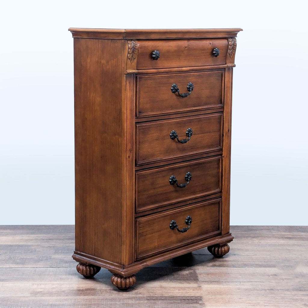 3. Side view of Elements oak dresser featuring ornate bronze handles and classic fluted bun feet design.