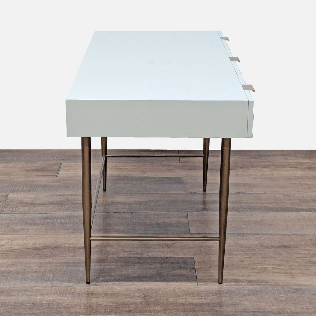 Side view of West Elm Audrey Desk, highlighting its sleek profile and antique brass leg design.