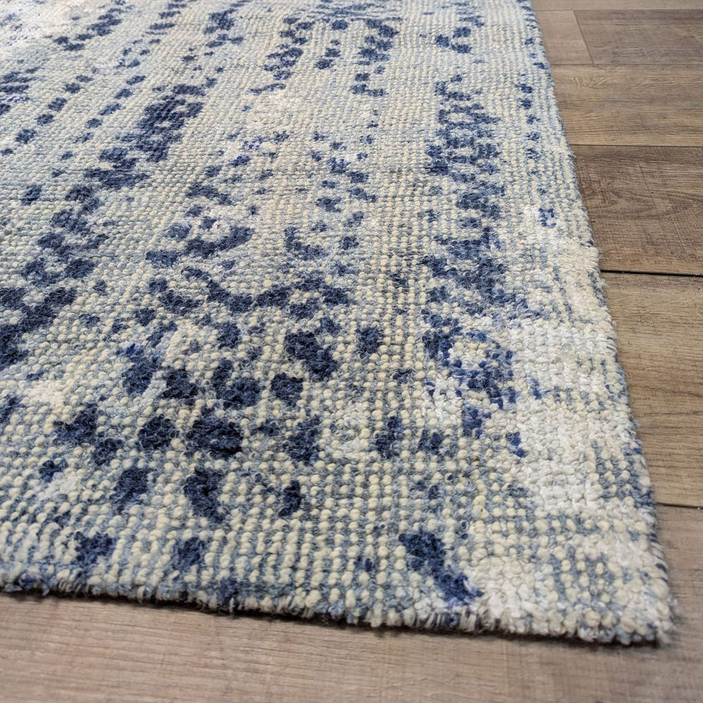 2. Close-up of a Reperch rug showcasing textured hand-loomed fibers and a softly cascading vine motif.  