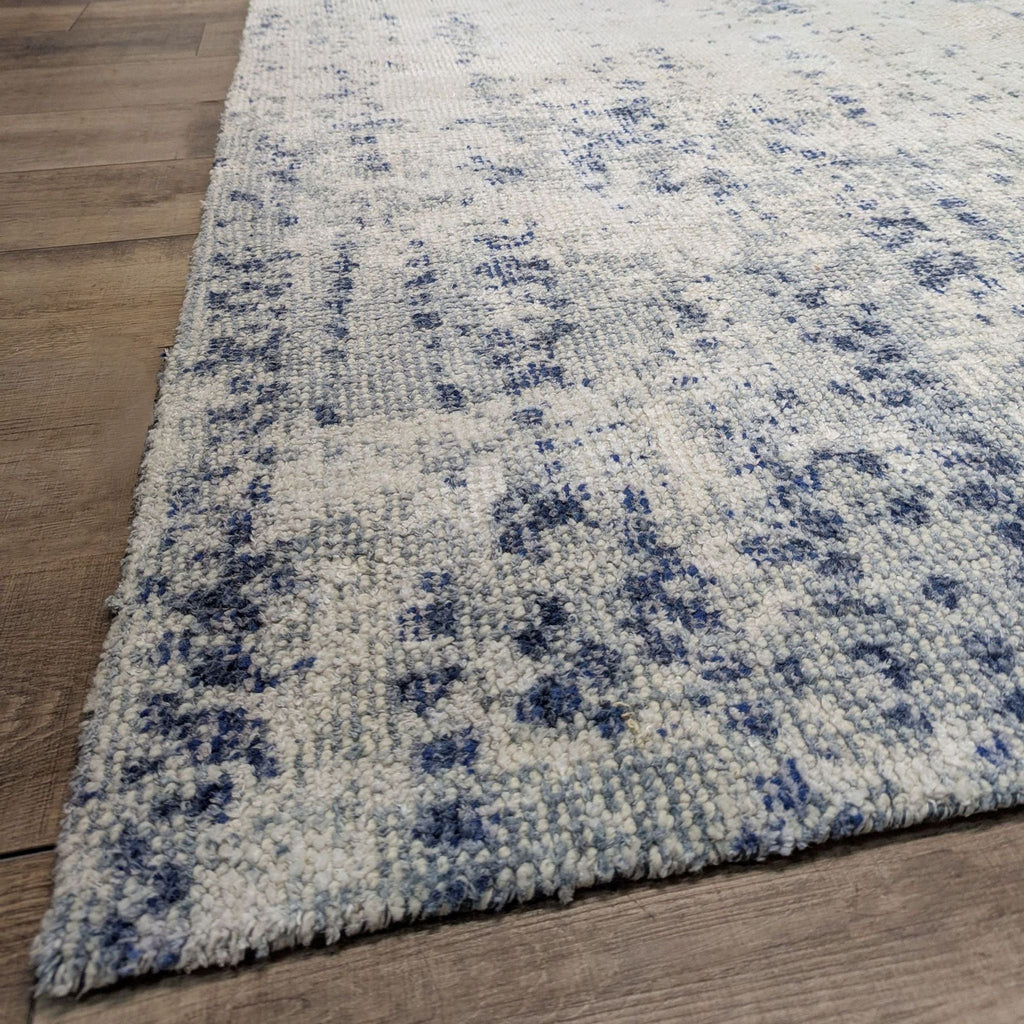 3. Detailed shot of Reperch rug's blue pattern, showing its distressed look and vine-inspired tonal design.