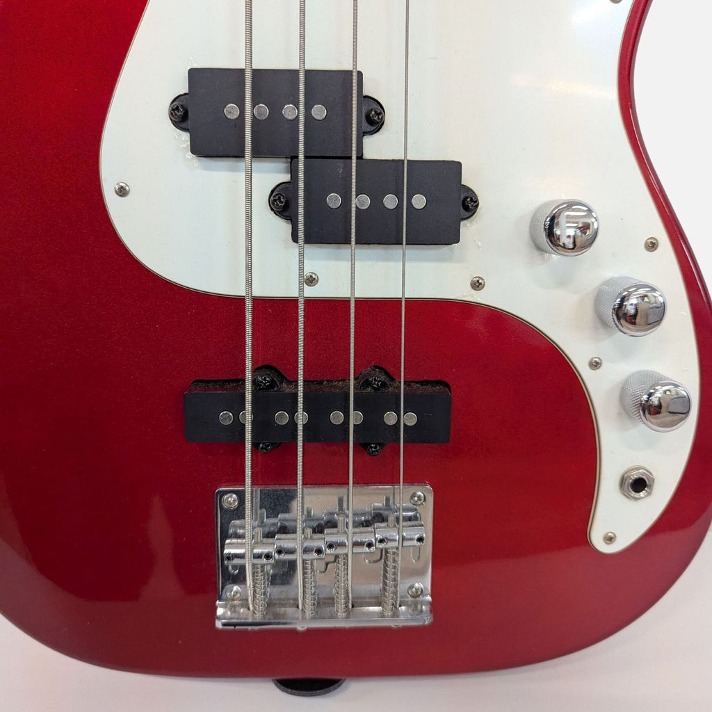 Red Corsair bass guitar featuring a solid body, chrome hardware, and a comfortable neck for easy playability.