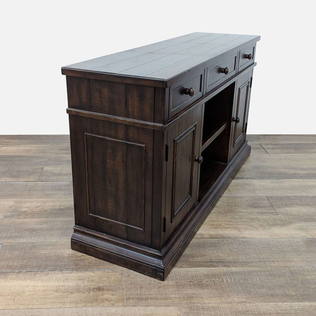 3. Angled view of a rustic Pottery Barn sideboard, highlighting its planked top, drawers, and shelving details.