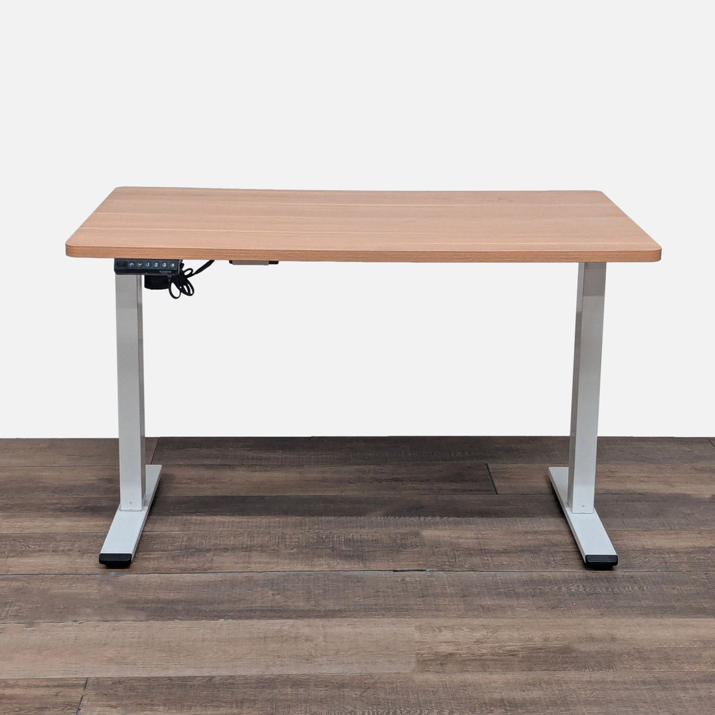 1. Flexispot adjustable height desk with wood laminate top, shown at its lowest position on wood flooring.  