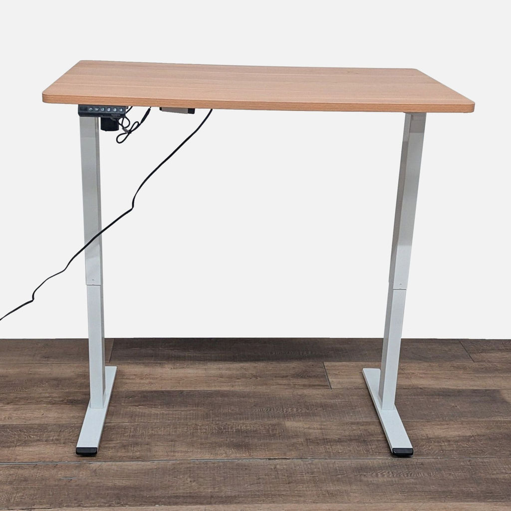 2. Flexispot desk with wood laminate top raised to standing height, featuring height-adjustable metal legs.  