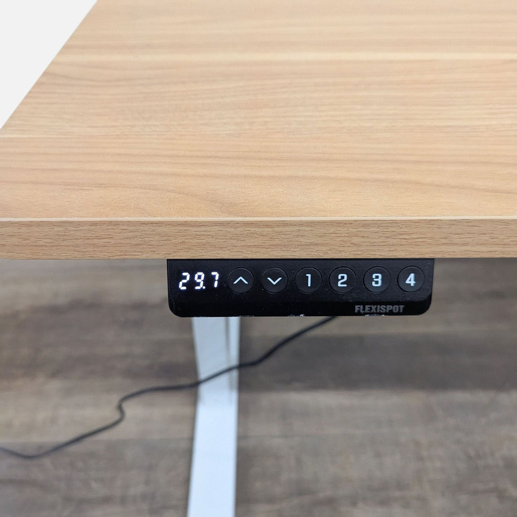 3. Close-up of Flexispot desk’s programmable control panel and wood laminate top, with digital height display.