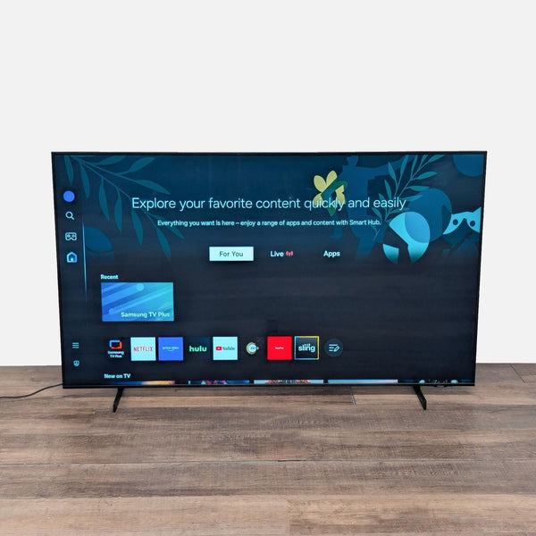 Samsung 65-inch 4K UHD Smart TV with popular apps on screen, slim design, and vibrant display, front view.  