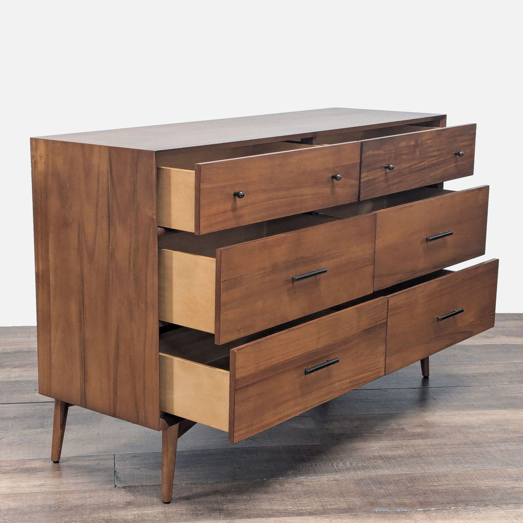 2. Angled view of West Elm mid-century dresser showing open drawers and wooden construction with slim handles.