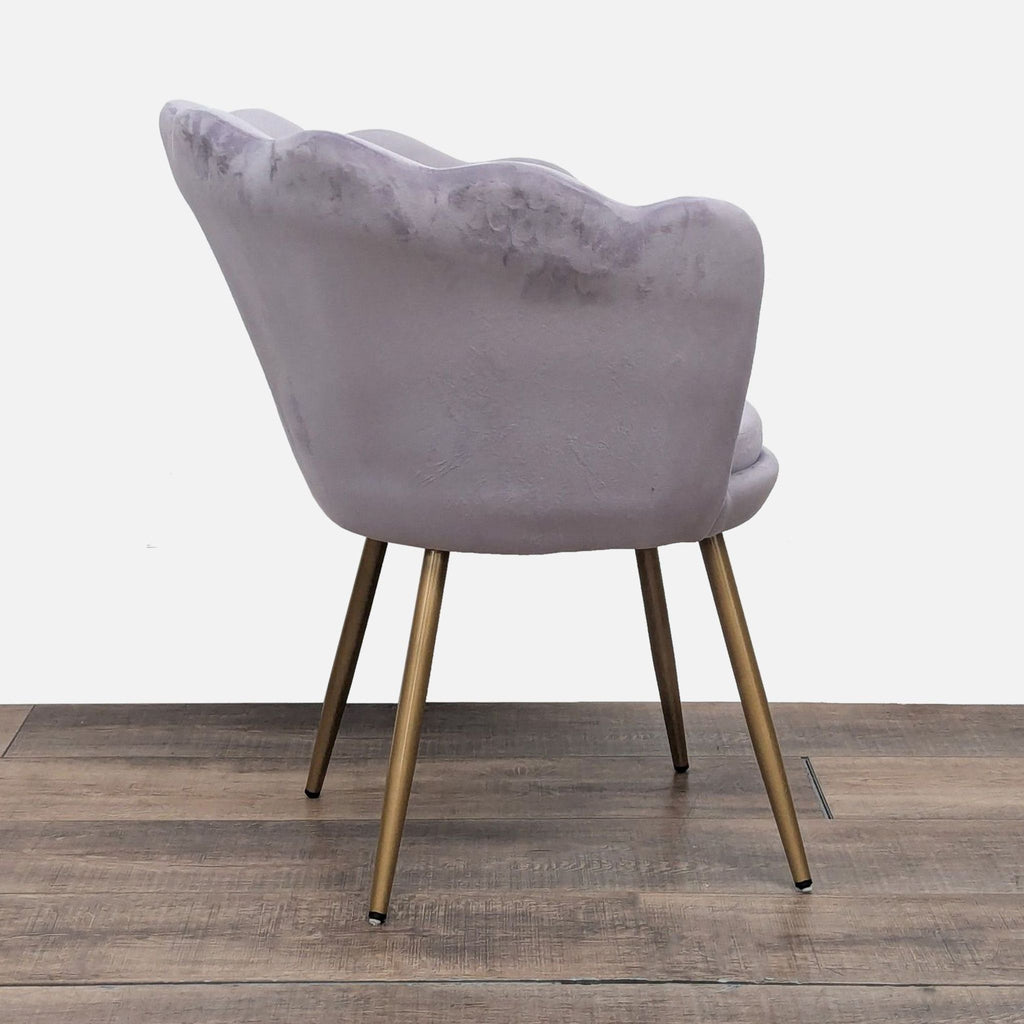 Angled back view of an Abble lounge chair showing scalloped edge details and gold-colored legs.