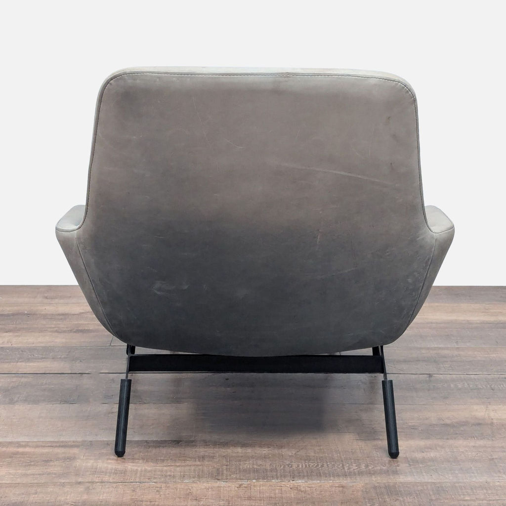 3. Rear view of Blu Dot lounge chair from the Lounge category, highlighting its curved shape and sturdy base.