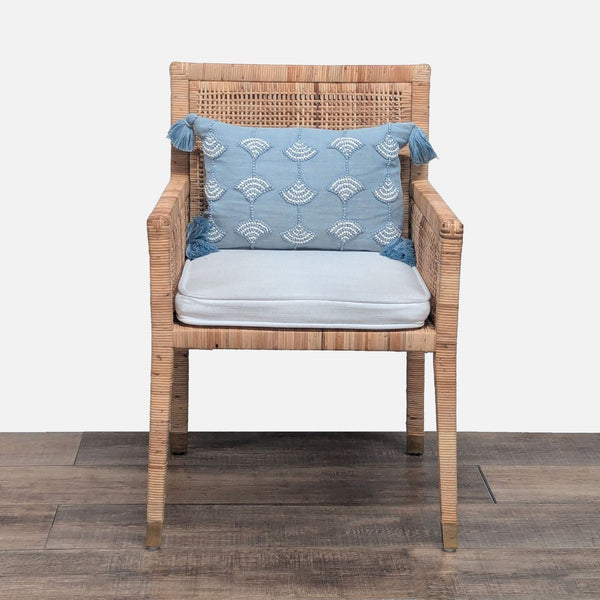 1. Front view of a Serena and Lily lounge chair with rattan weave, brass-capped feet, and a removable cushion.