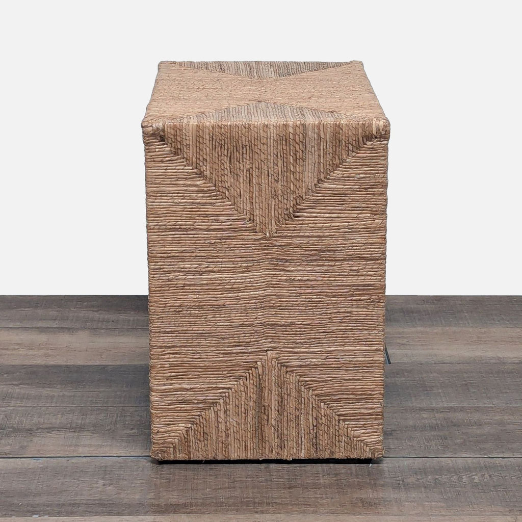 2. Side view of handcrafted console table, showing textured seagrass wrap and geometric detail on the ends.  