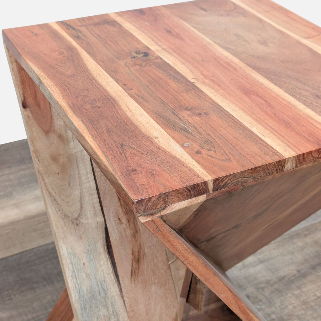 Close-up view of the Reperch side and console table’s smooth rectangular wood top and angled base design.