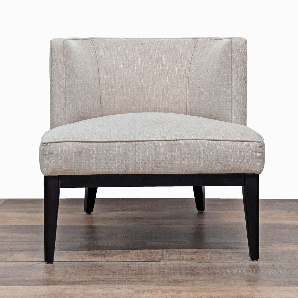 1. Crate and Barrel lounge chair with tailored upholstery, barrel shaped back and wood legs, front view.