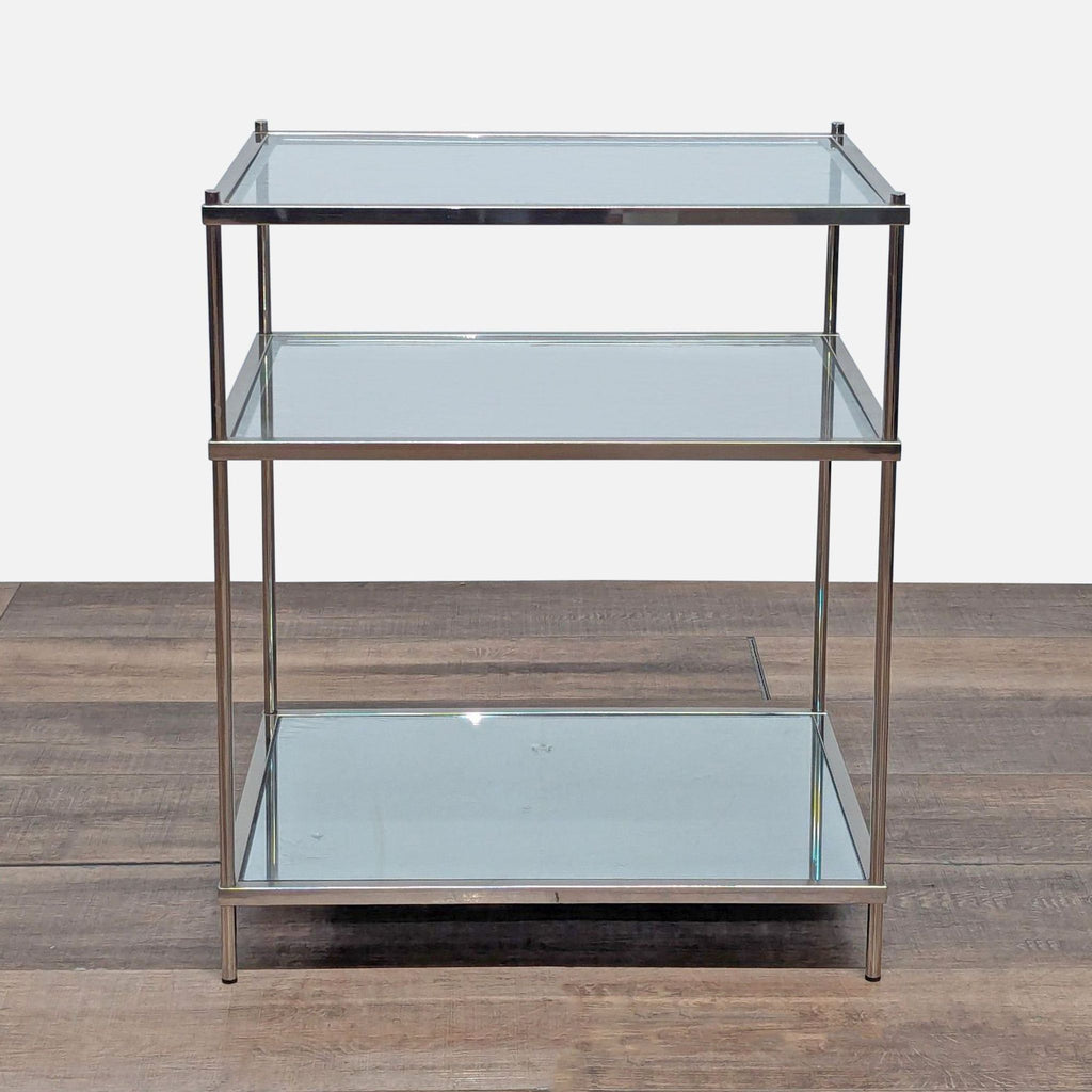 1. Crate and Barrel end table with metal frame, two glass shelves, and a mirrored bottom shelf, modern design.  