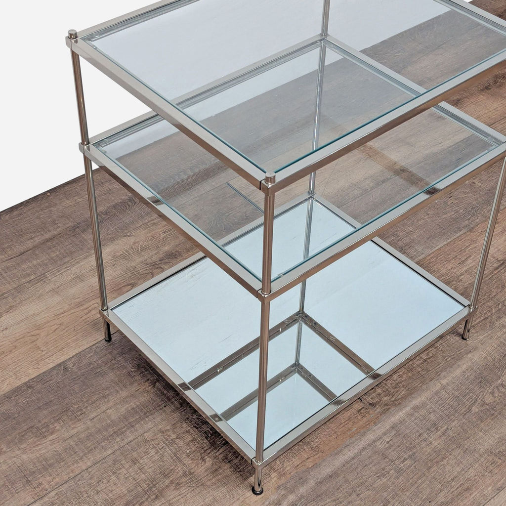 3. Modern Crate and Barrel end table with glass top, middle shelf, mirrored glass bottom, and metal frame.