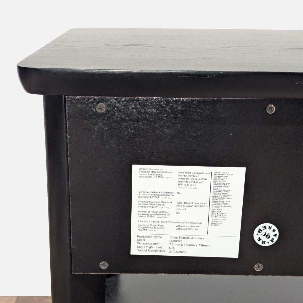 3. Close-up of the back of a Pottery Barn end table, featuring manufacturer and product information label.