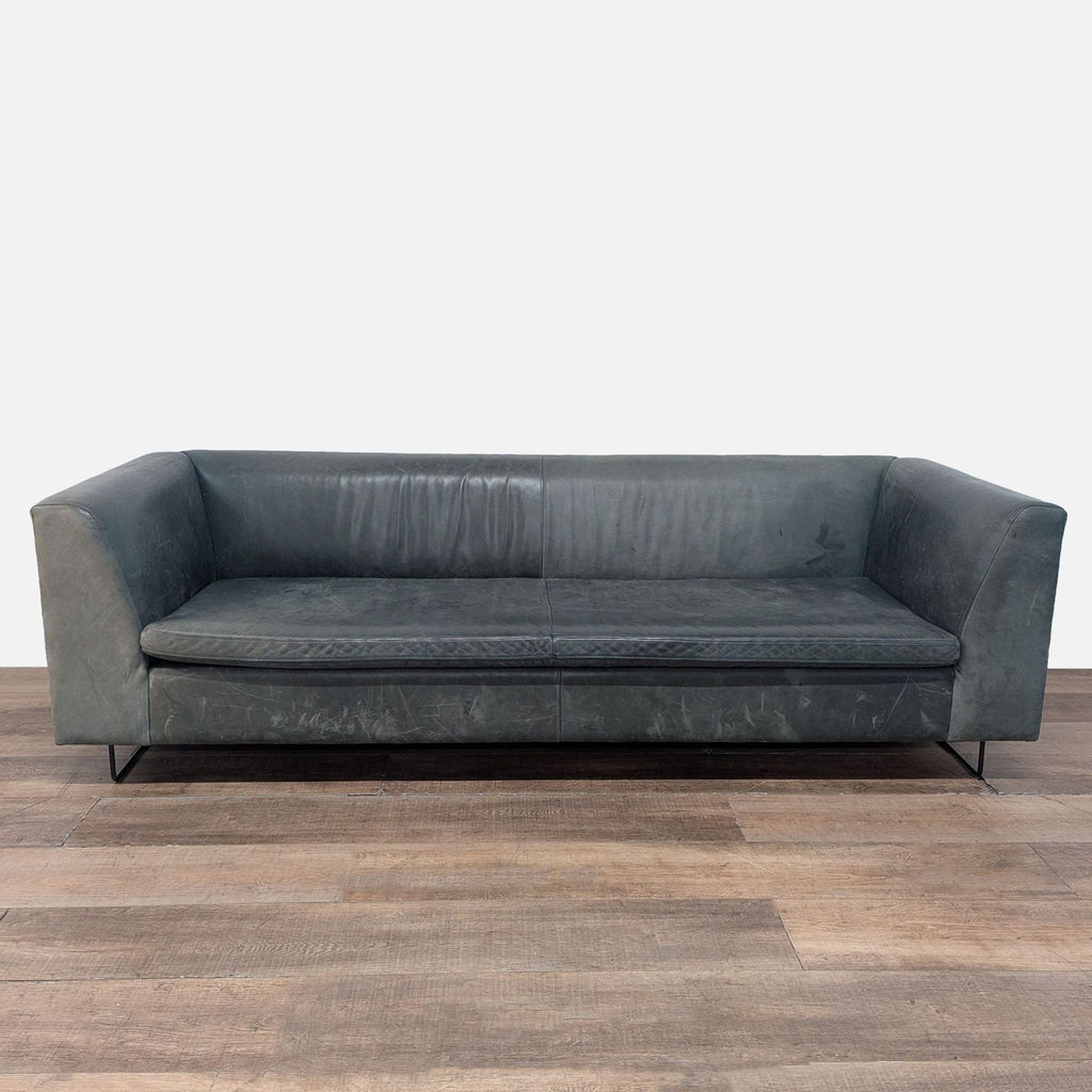 1. Blu Dot 3-seat sofa with modern leather upholstery and metal legs, shown from the front on wood flooring.
