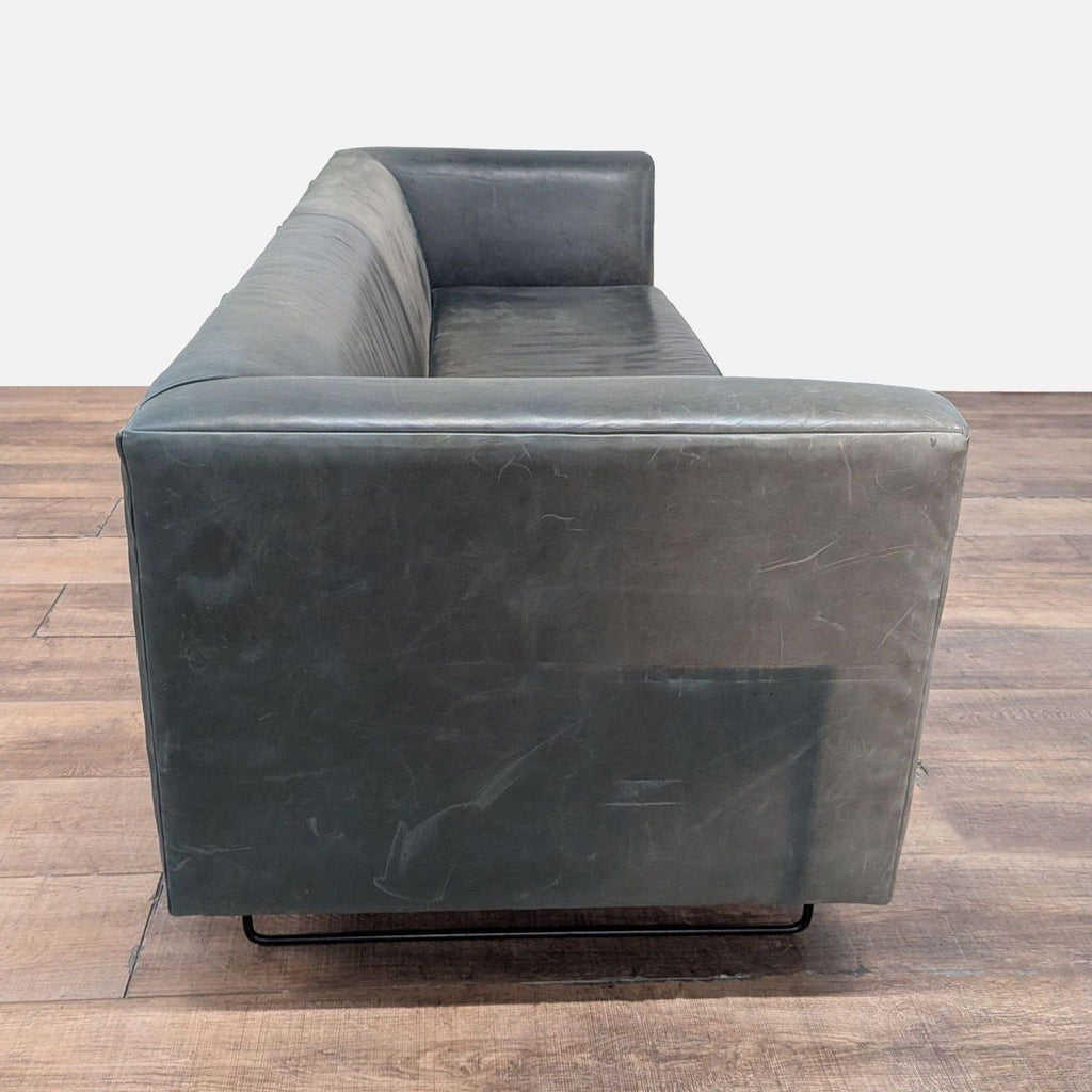 2. Side view of Blu Dot 3-seat modern sofa, featuring leather upholstery and metal legs.