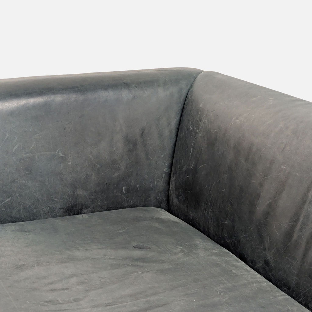 3. Close-up of leather upholstery and armrest corner on Blu Dot modern 3-seat sofa.