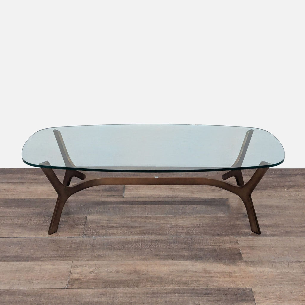 3. Angled view of Crate & Barrel coffee table in the coffee table category, with a glass top and brass base.