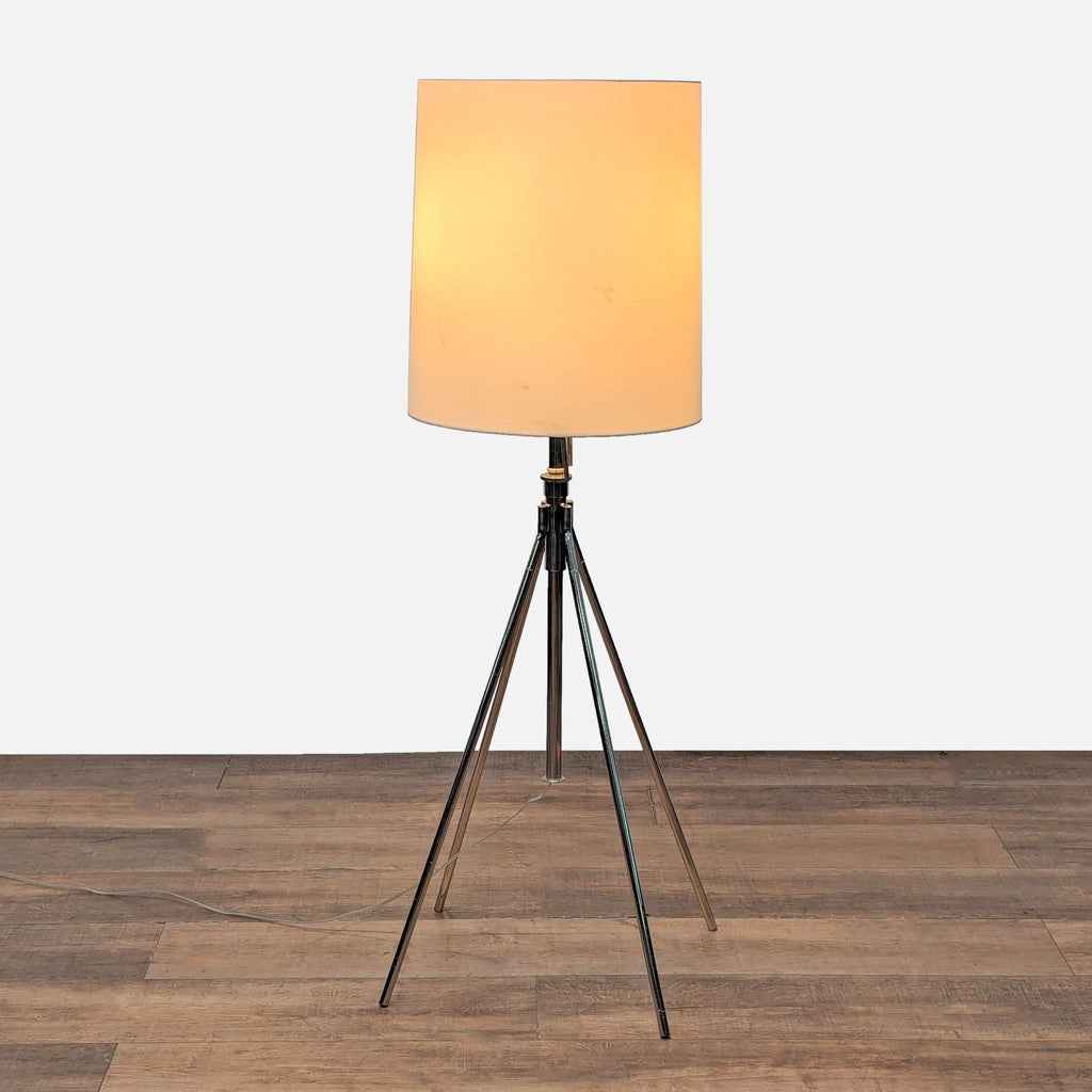 1. West Elm lamp with adjustable metal tripod base and fabric drum shade, shown on a wooden floor.  