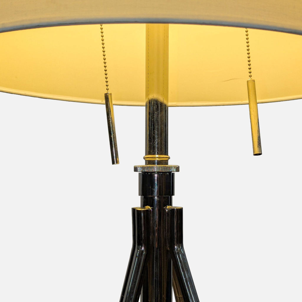 2. Close-up of lamp’s chrome tripod base, adjustment knob, and fabric drum shade with pull chains.  