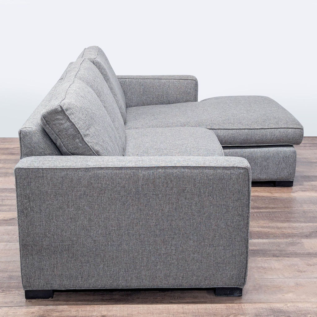 2. Modern grey sectional by Room and Board, featuring clean track arms, a chaise, and soft comfort cushions.