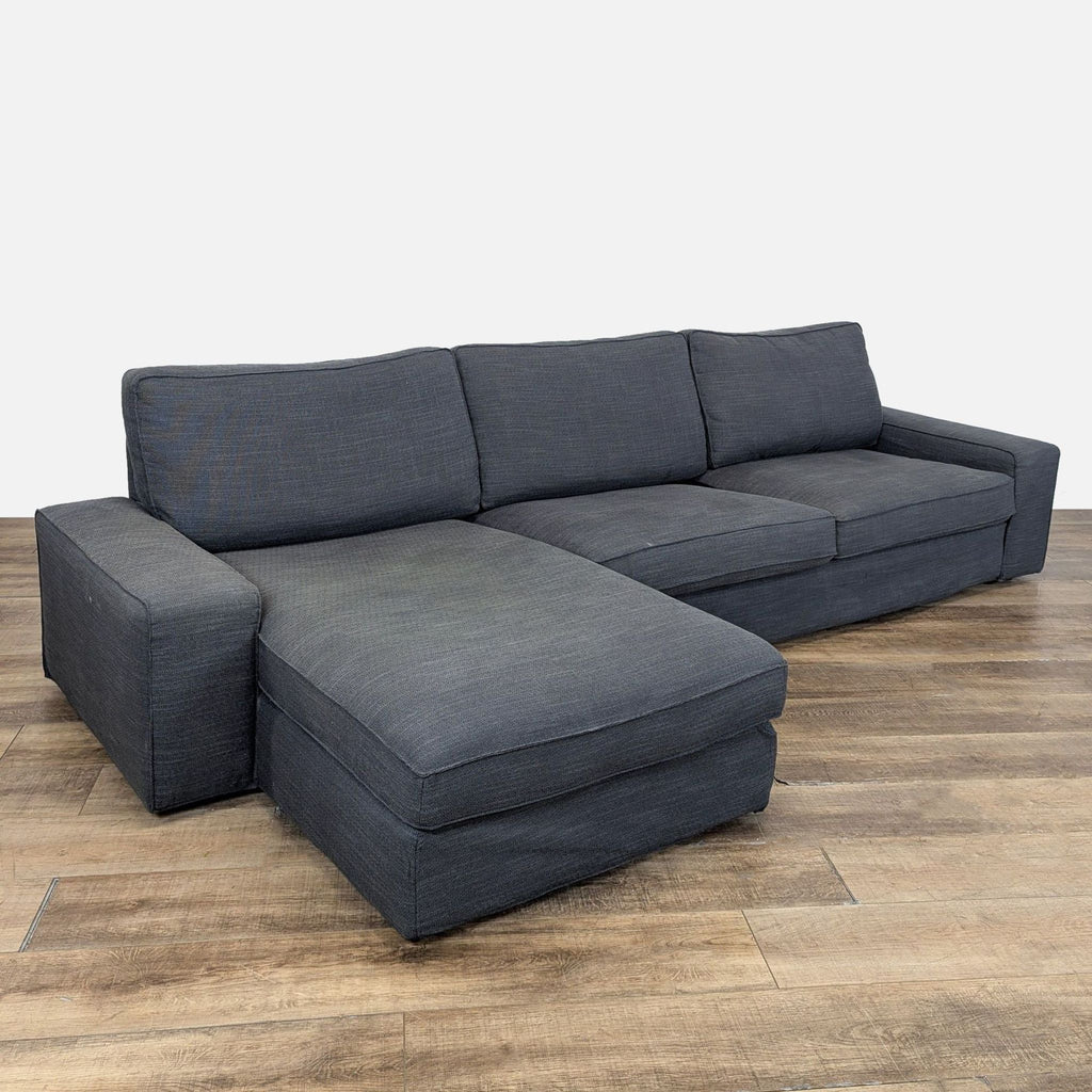 3. Angled shot of an Ikea sectional sofa with high resilience foam cushions and wide arms for firm, relaxing comfort.