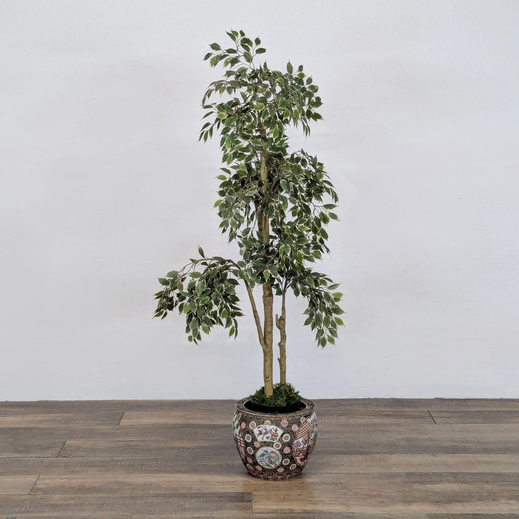 Potted artificial tree with variegated leaves in a decorative, Asian-inspired ceramic planter by Reperch.