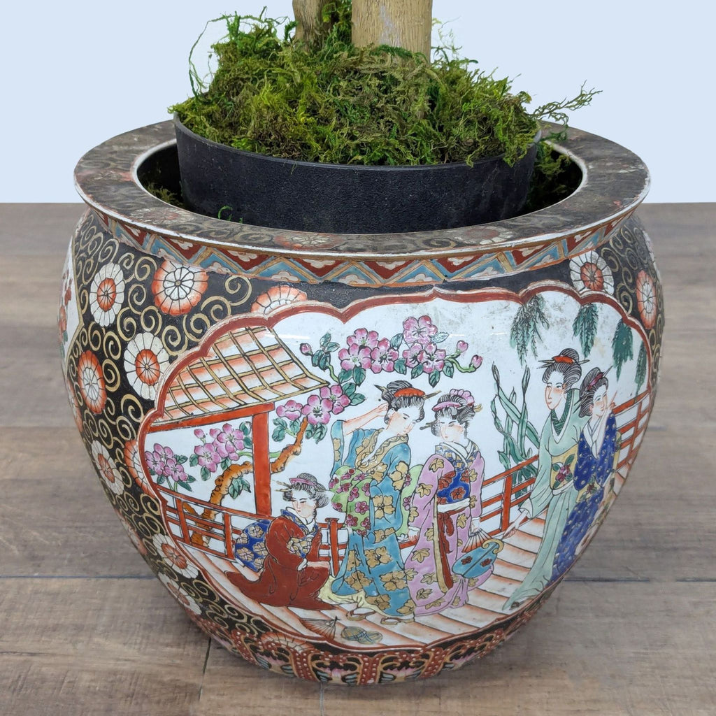 Close-up of planter showing colorful Japanese-style figures and floral designs, with moss at the base.