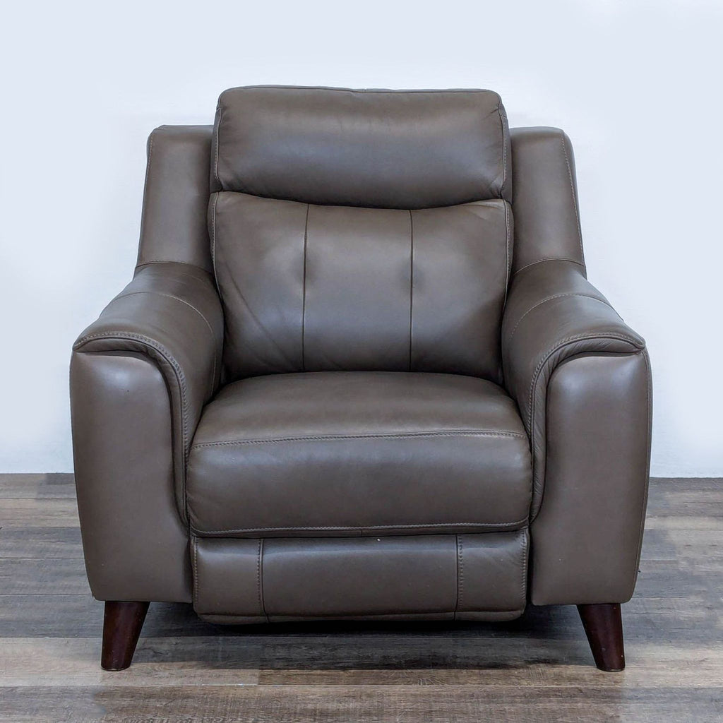 1. Brown leather Leggett & Platt lounge recliner chair, featuring plush cushions and wooden legs, front view.