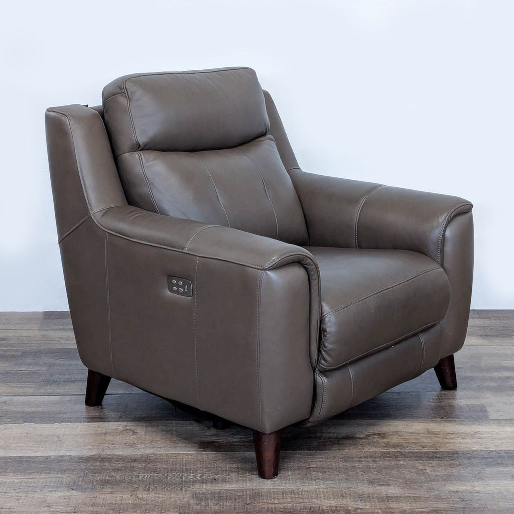 3. Angled view of lounge leather recliner with visible control panel on armrest, Leggett & Platt brand.