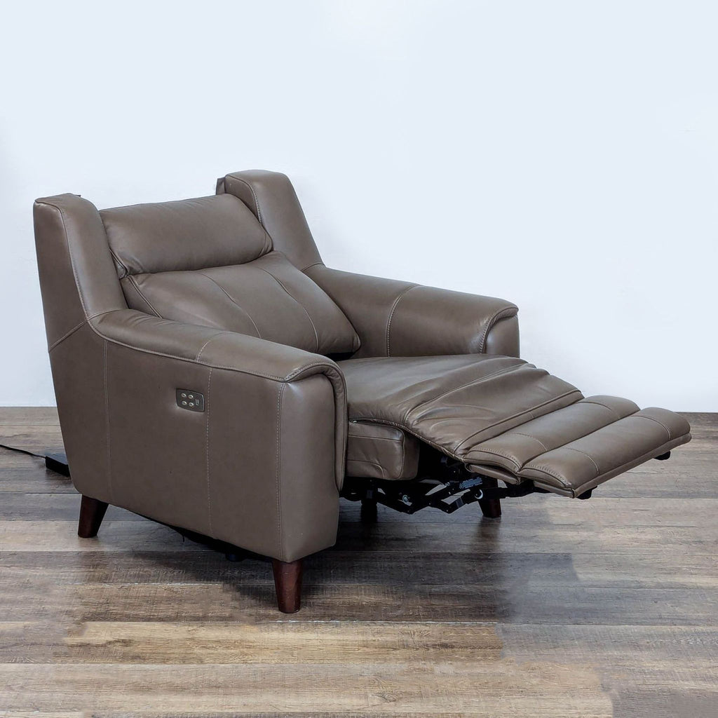 2. Side view of a Leggett & Platt brown leather recliner extended, showing power control panel and footrest.