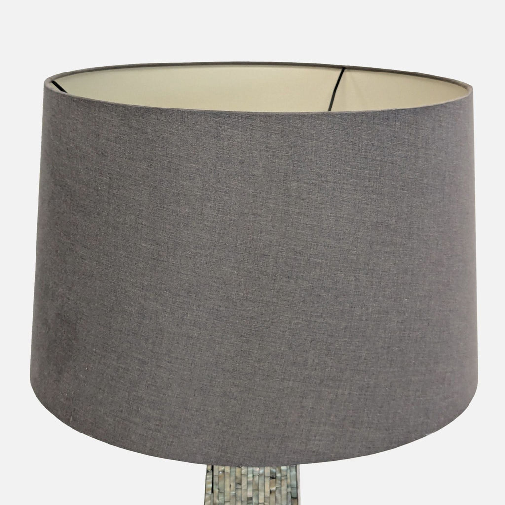 3. Detail of the lamp's neutral drum shade with a subtle fabric texture, complementing the elegant base.