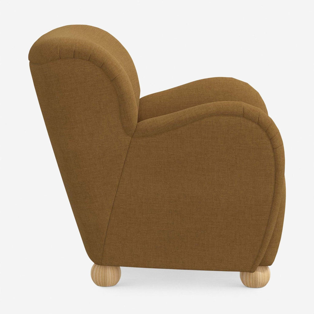 2. Side profile of Lulu and Georgia lounge chair, featuring plush arms and contoured seat on rounded wood feet.  
