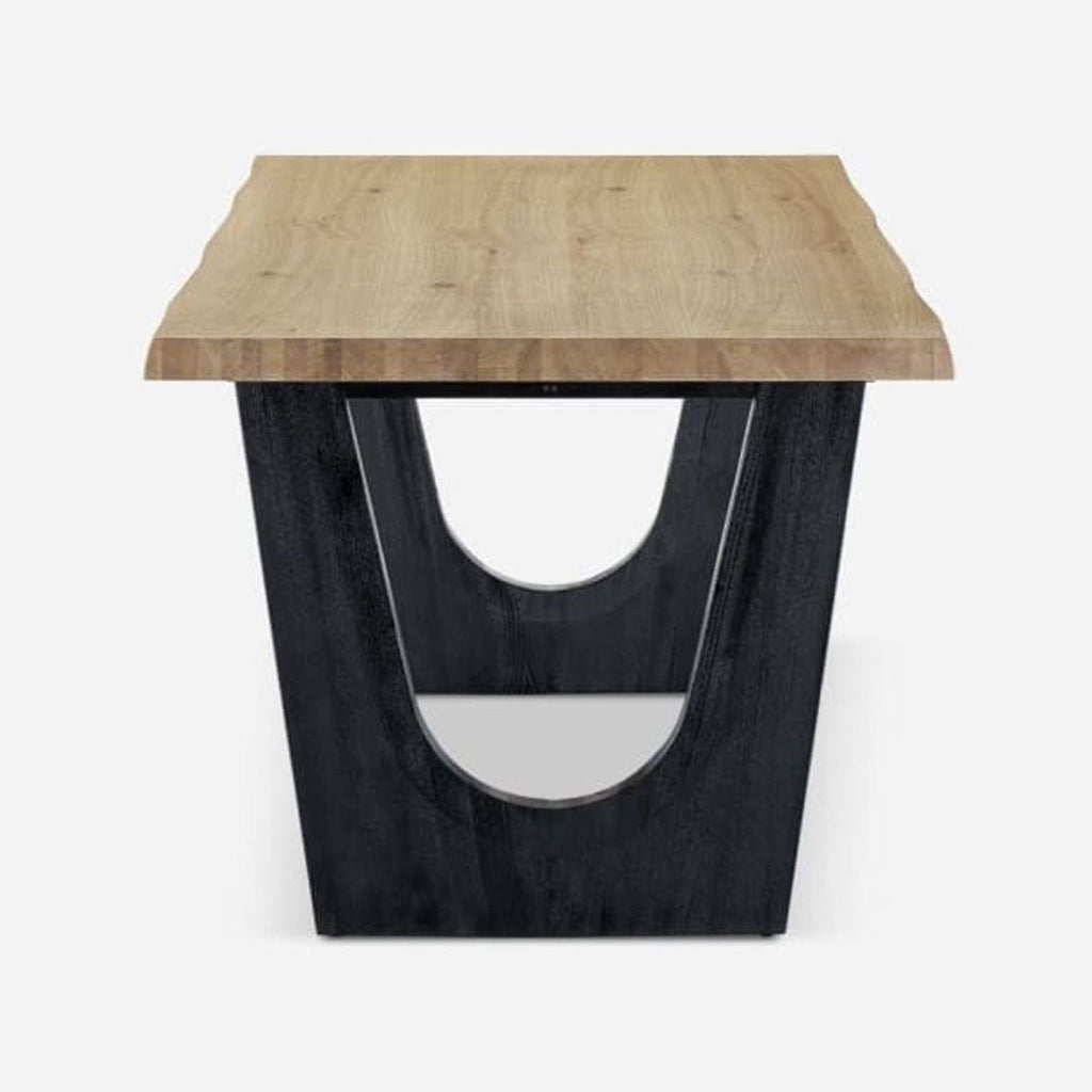 2. End view of Castlery dining table showing wood grain top and sturdy wire brushed black leg.