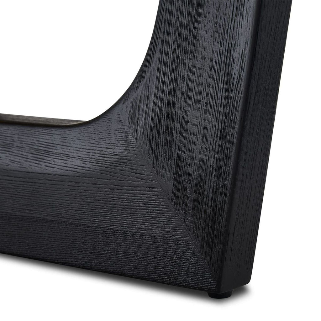 3. Detailed close-up of solid elm dining table leg, showing wire brushed black textured finish.