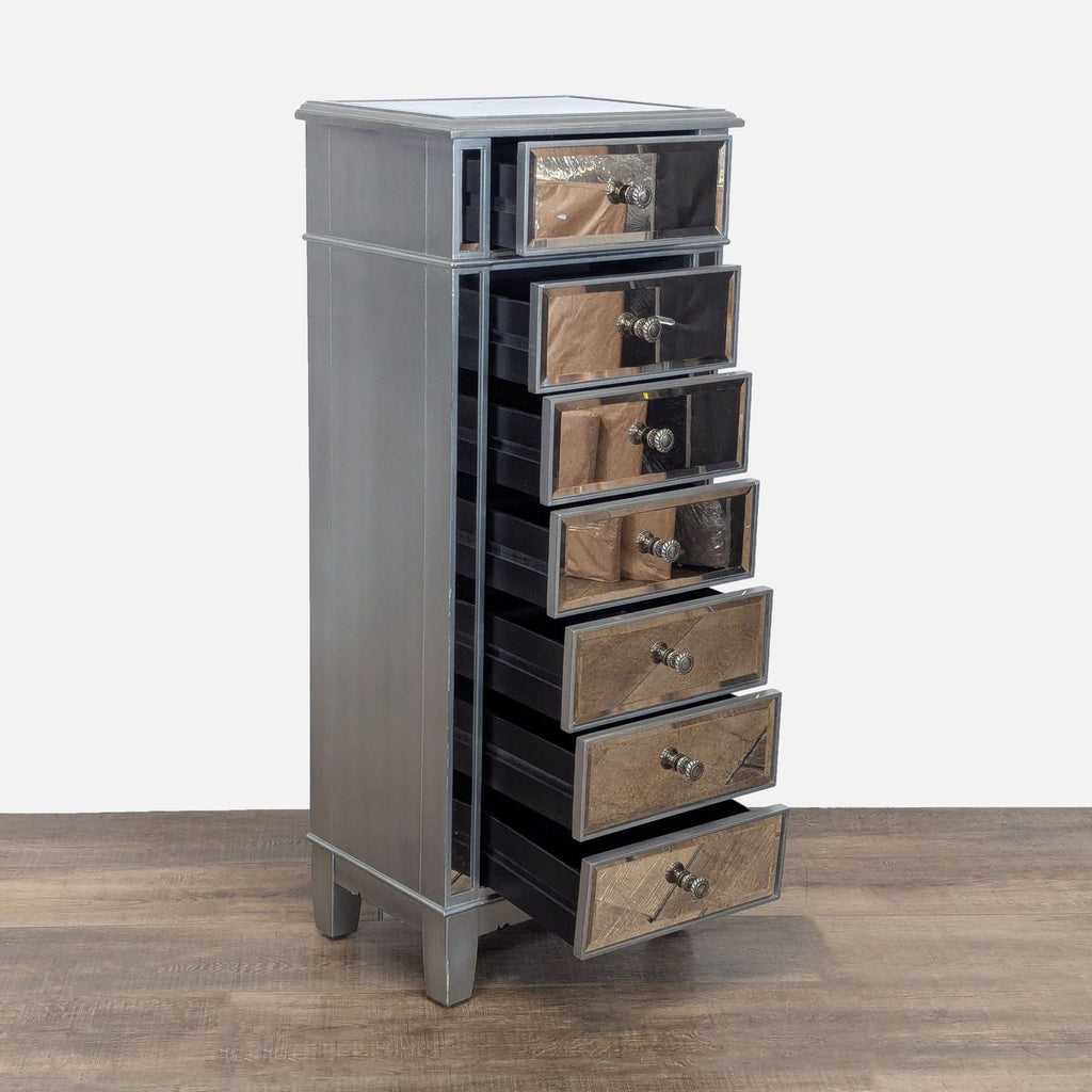 2. Side view of silver Pier 1 Imports chest with mirrored drawers partially open, set on wooden floor.