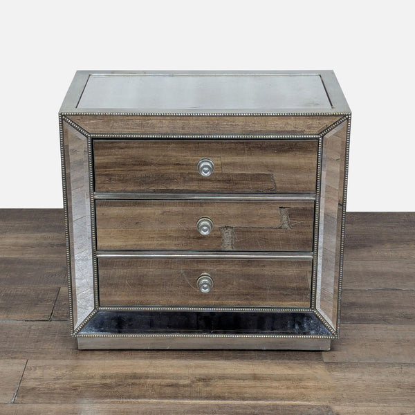 1. Z Gallerie end table with mirrored panels and silver leaf finish, featuring three drawers and decorative trim.  