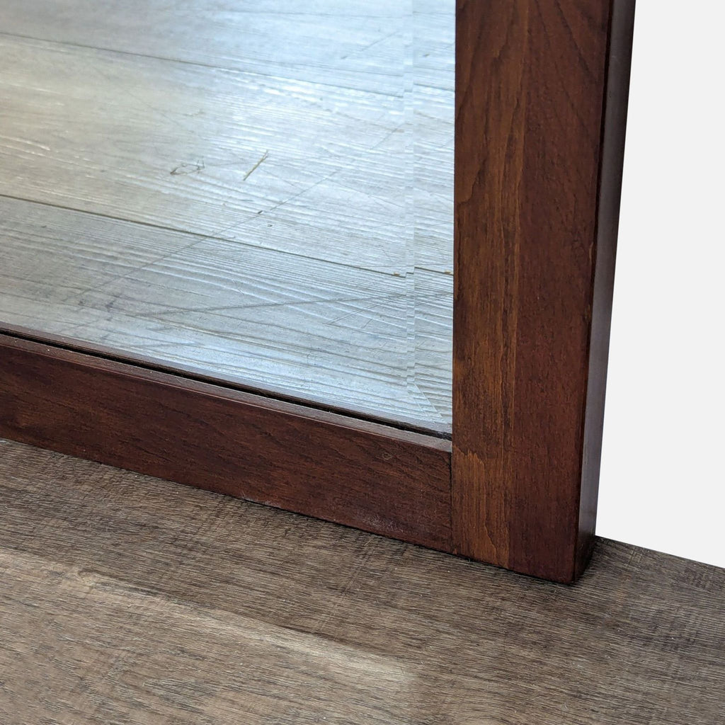 3. Close-up of the Ethan Allen mirror's wood frame corner, highlighting the rich finish and joinery.