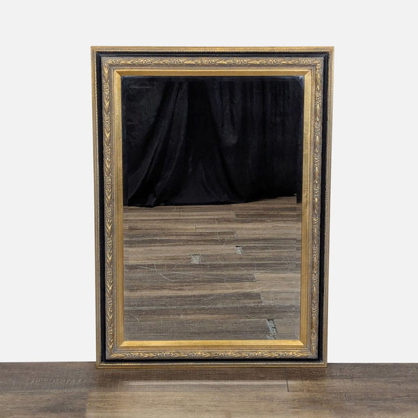 1. Rectangular Reperch mirror with a gold and black ornate frame, reflecting hardwood floor and dark curtain.