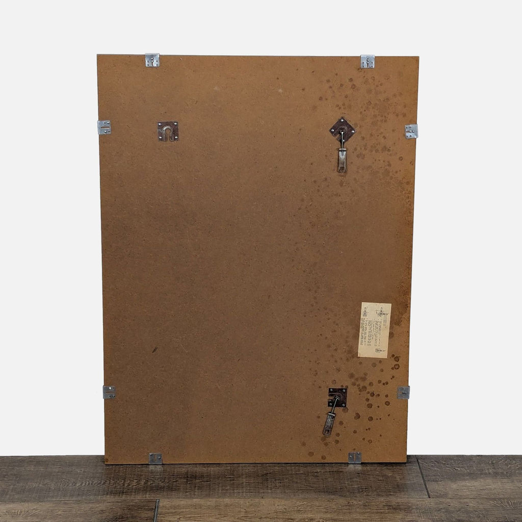 2. Back view of a Reperch mirror showing brown panel, mounting brackets, and a product label.