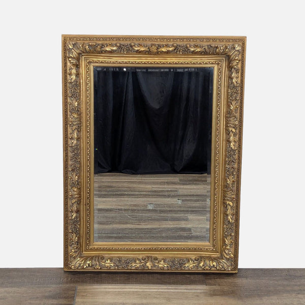 1. Ornate Reperch mirror with an intricately carved gold frame, displayed on a wood floor against a black backdrop.