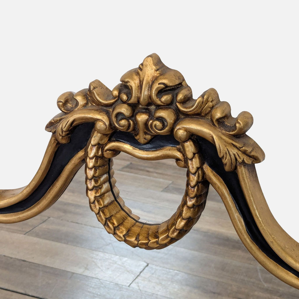 2. Close-up of the top arch of the Reperch mirror, showing detailed black and gold decorative accents.